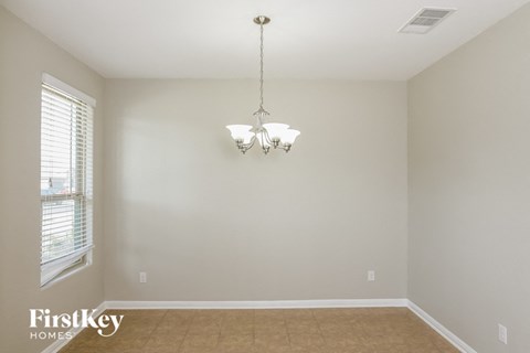 A room with a chandelier hanging from the ceiling.