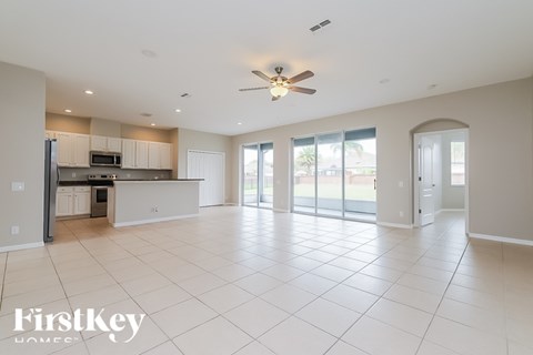 A spacious kitchen with a refrigerator, microwave, and oven.
