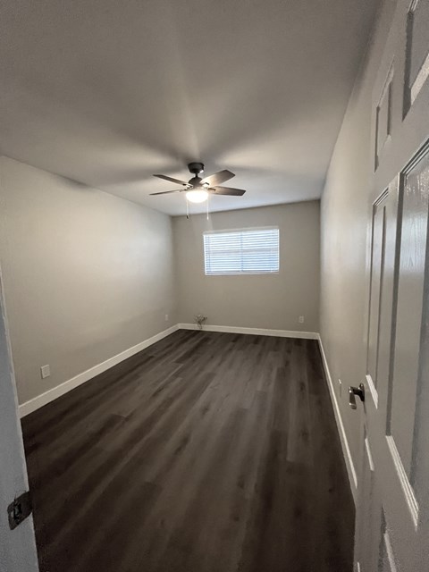 a room with hardwood floors and a ceiling fan