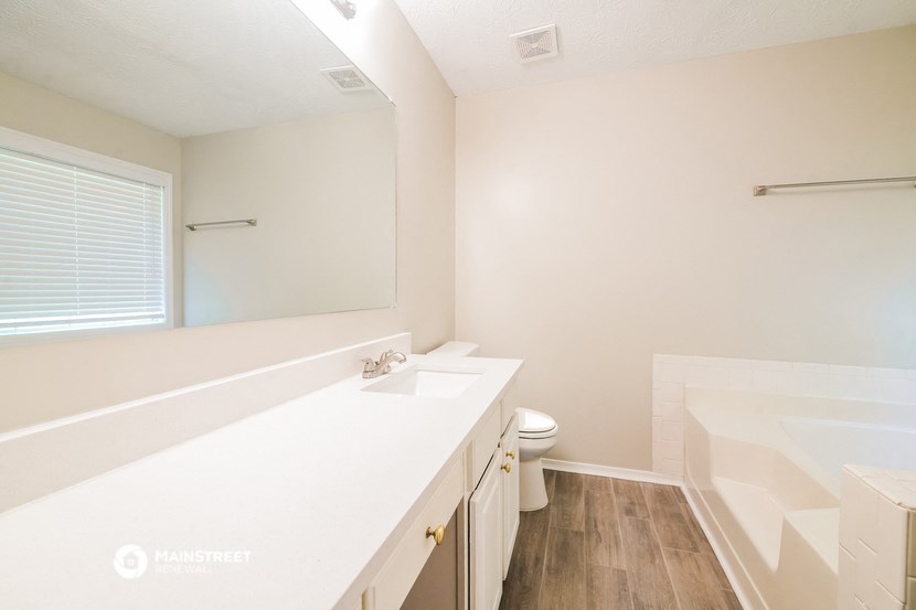 a bathroom with a sink and a toilet and a mirror