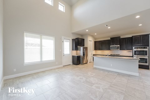 a kitchen with black cabinets and stainless steel appliances