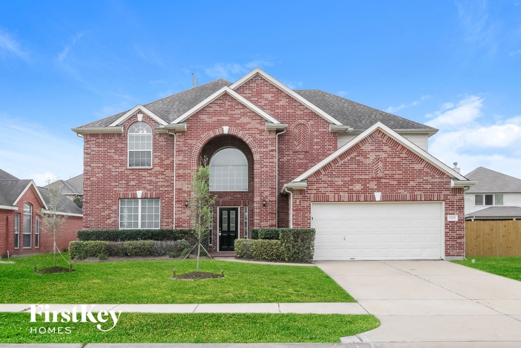 a red brick house with a white garage door