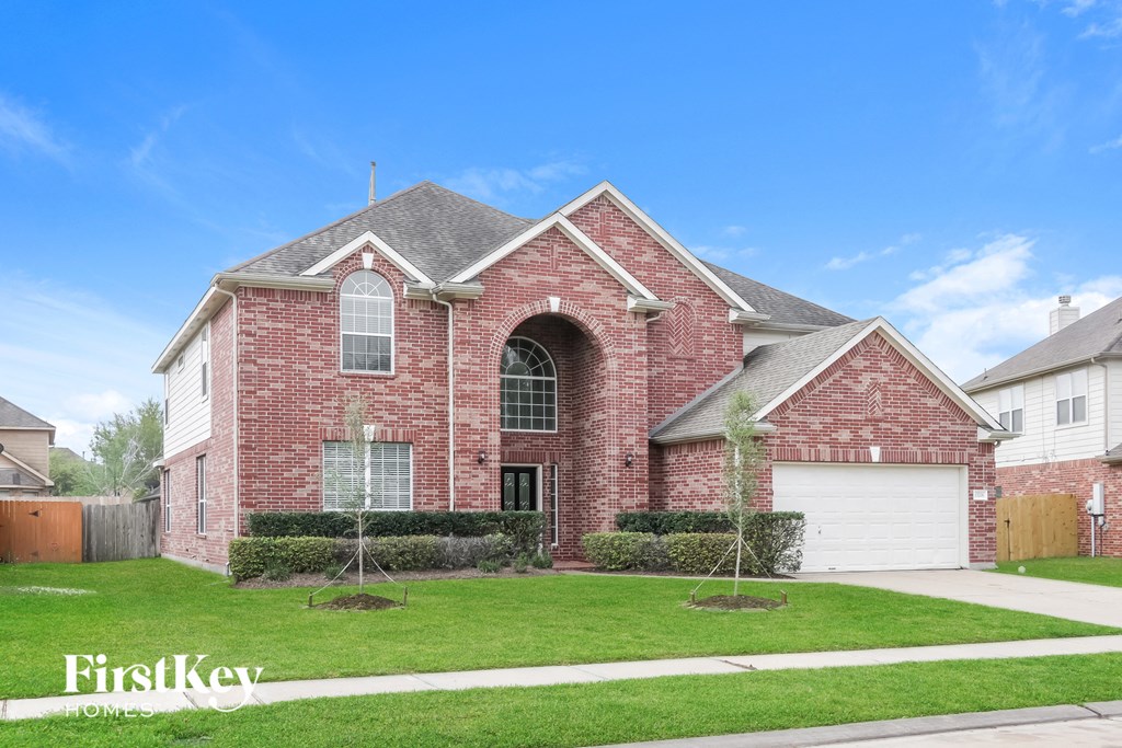 a brick house with a lawn in front of it