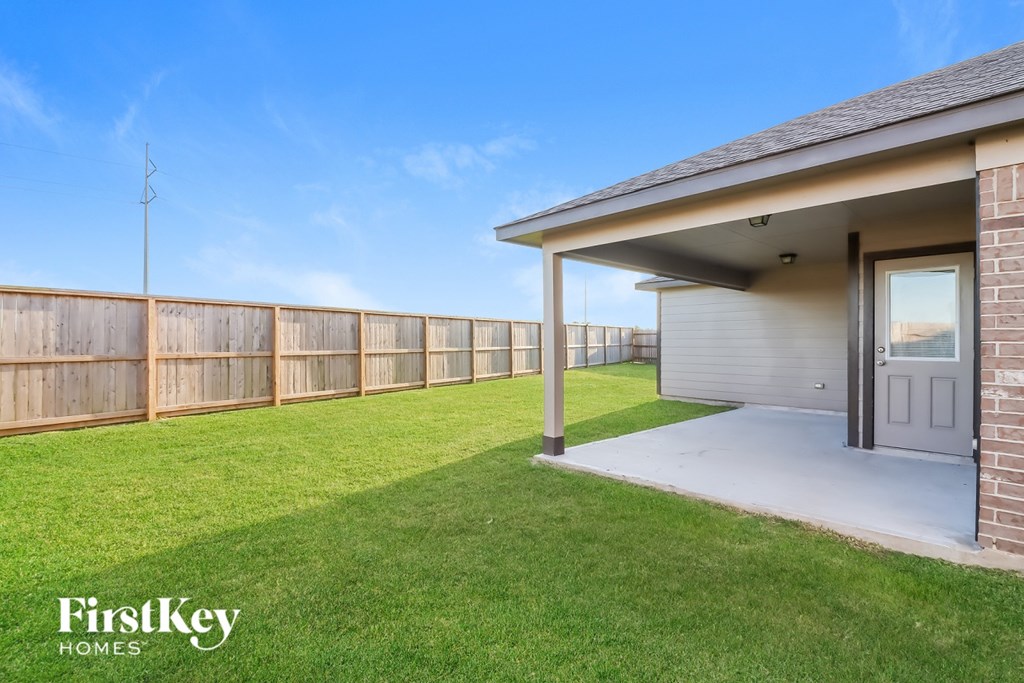A house with a fence and a grassy yard.