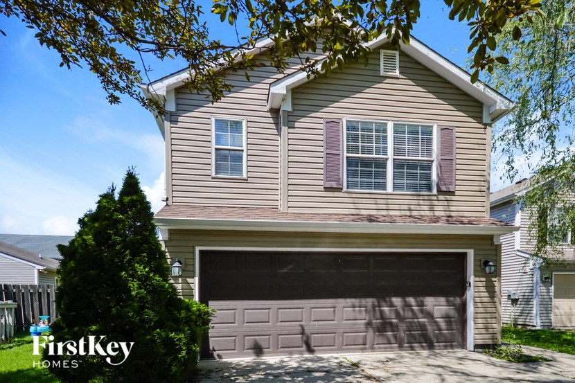 a house with a garage door in front of it