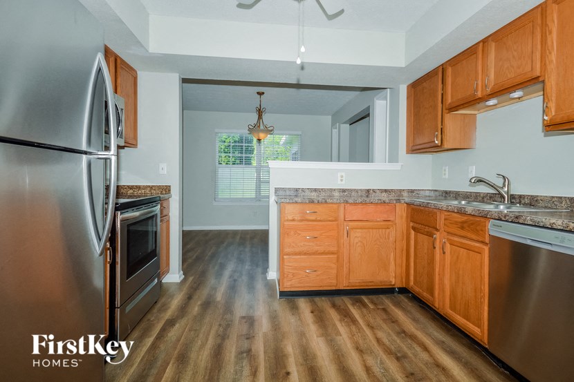a kitchen with wooden cabinets and stainless steel appliances