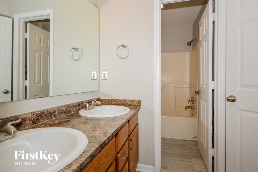 a bathroom with two sinks and a large mirror