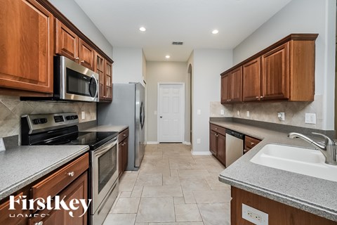 A kitchen with wooden cabinets and a white refrigerator.