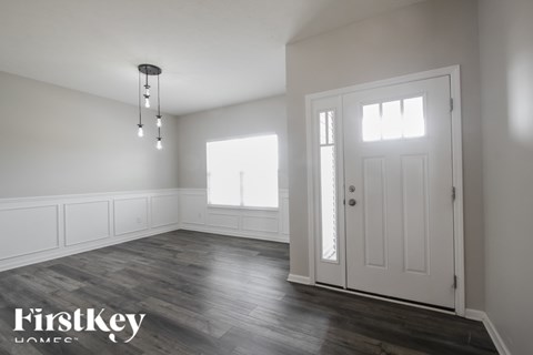 A room with a wooden floor and a white door.