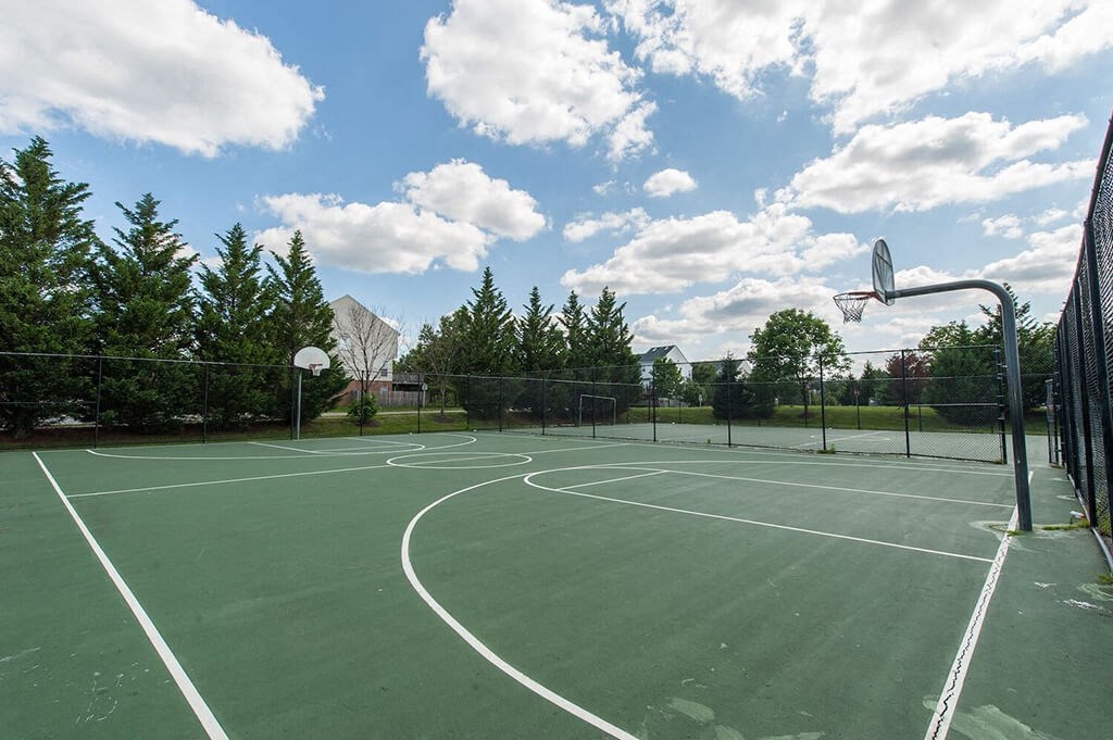 a tennis court with a basketball hoop on it