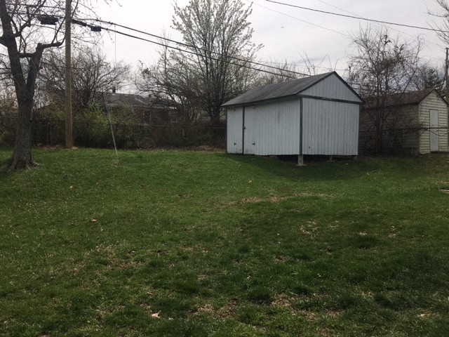 a shed in the grass in a backyard