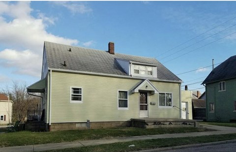 a white house on the side of a street