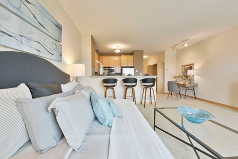 A modern living room with a grey sofa and a glass coffee table.