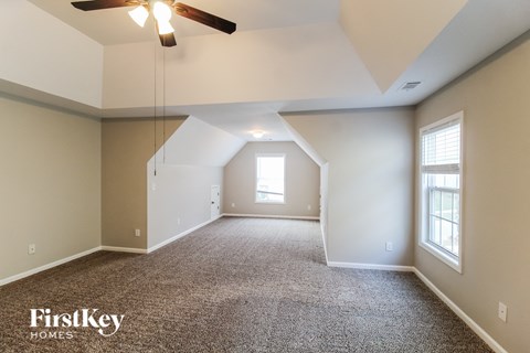 the master bedroom is spacious and has a ceiling fan