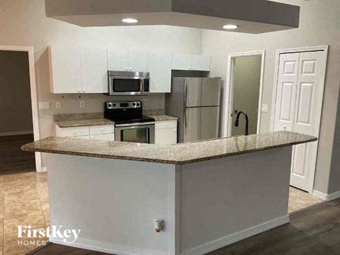 a kitchen with a counter top and a refrigerator