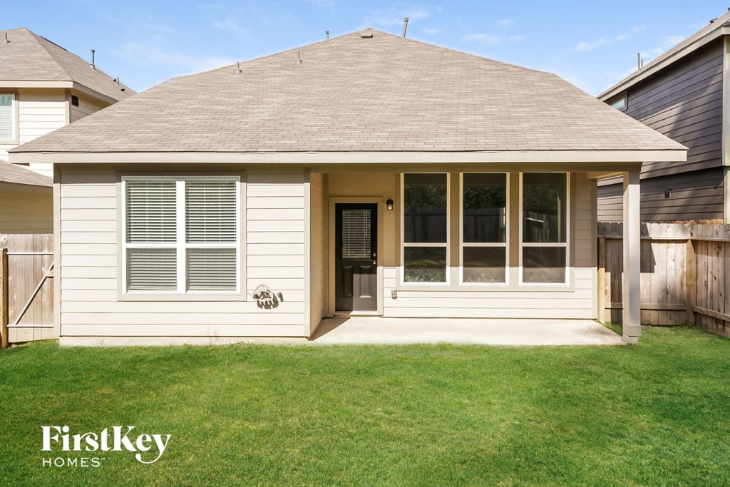 the front of a white house with a porch