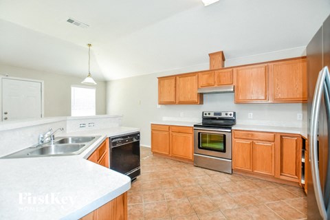 a kitchen with wooden cabinets and stainless steel appliances