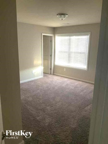 an empty room with a window and a door