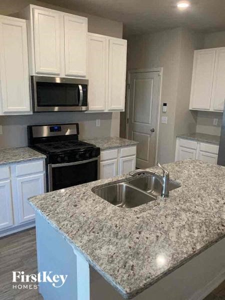 a kitchen with white cabinets and a sink