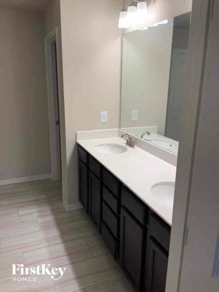 a bathroom with two sinks and a large mirror