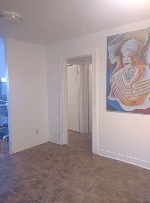 a painting of a woman on a wall in a room