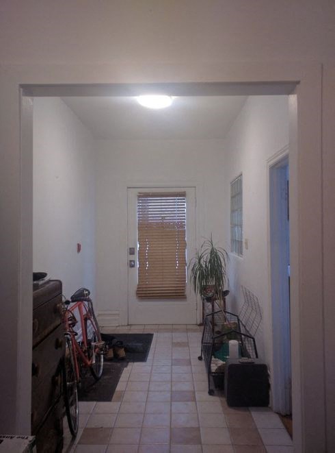 a room with two bikes in it and a door