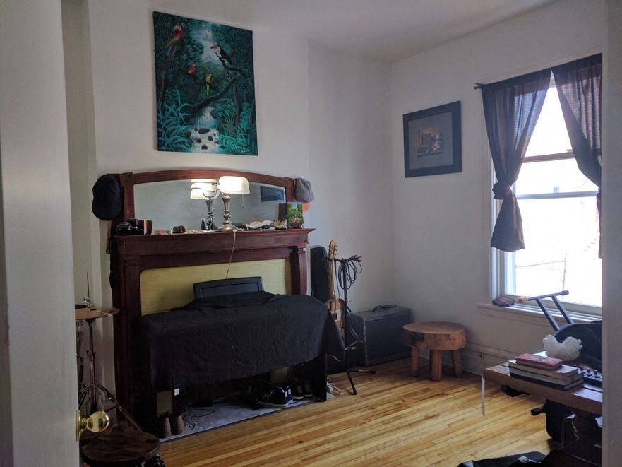 a bedroom with a bed and a mirror in it