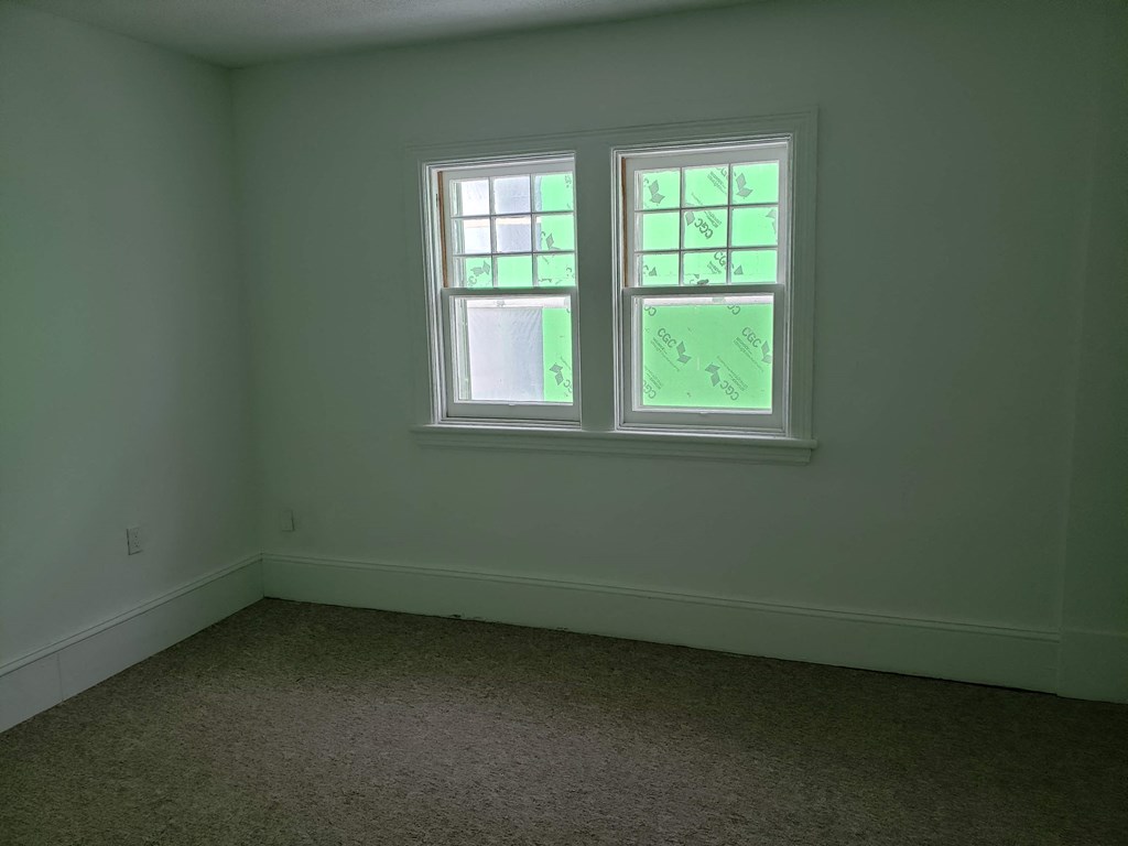 a room with a window and a carpet