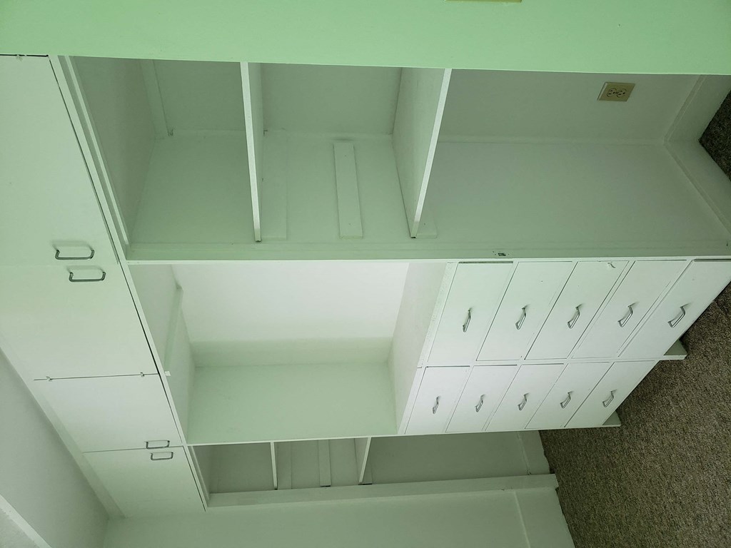an overhead view of two white cabinets in a room