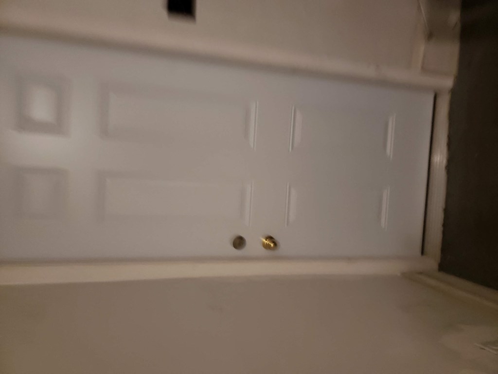 a white door with a gold door knob on it