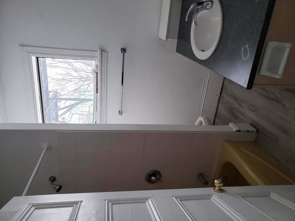 a bathroom with a sink and a window