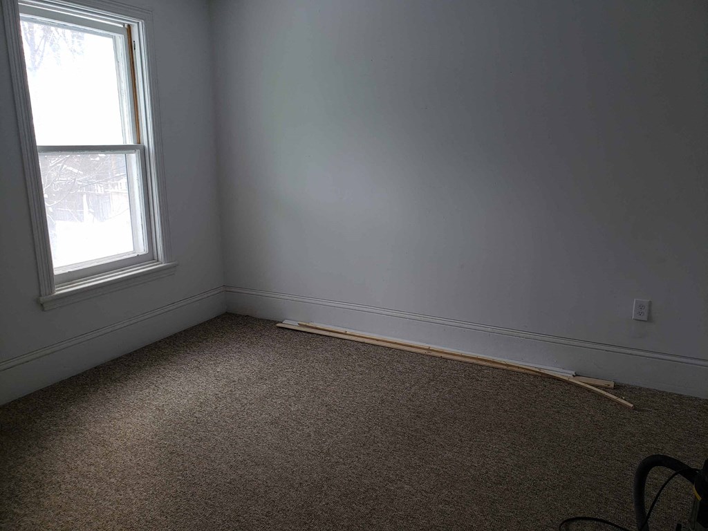 a room with white walls and a window