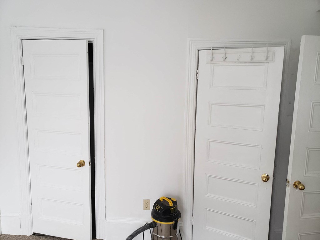 a fire hydrant sitting next to two white doors