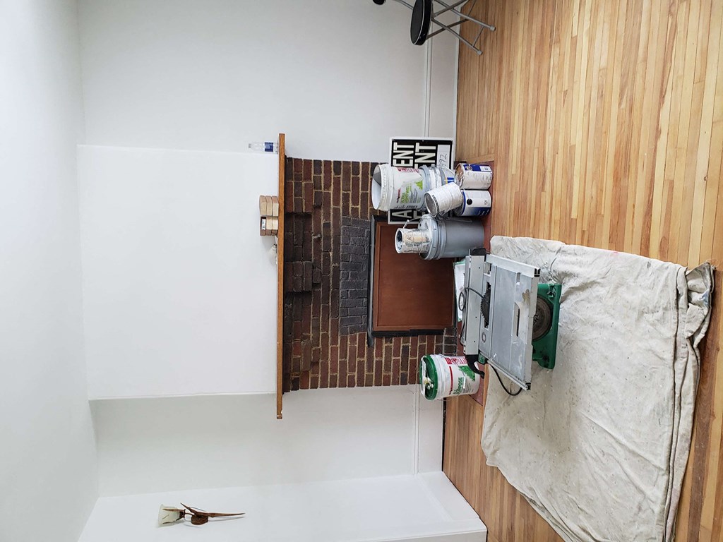 an overhead view of a bathroom with wood flooring and a sink