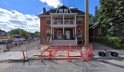 a red brick house with orange cones in front of it