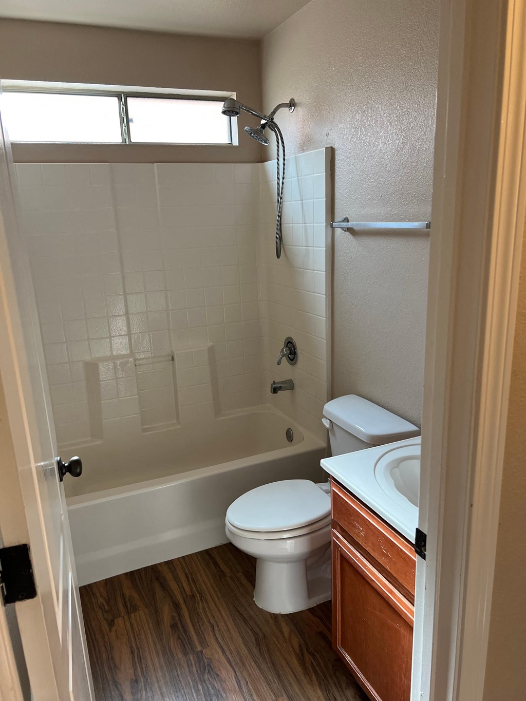 a bathroom with a toilet and a tub and a sink