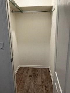 a white closet with a sliding door in a room