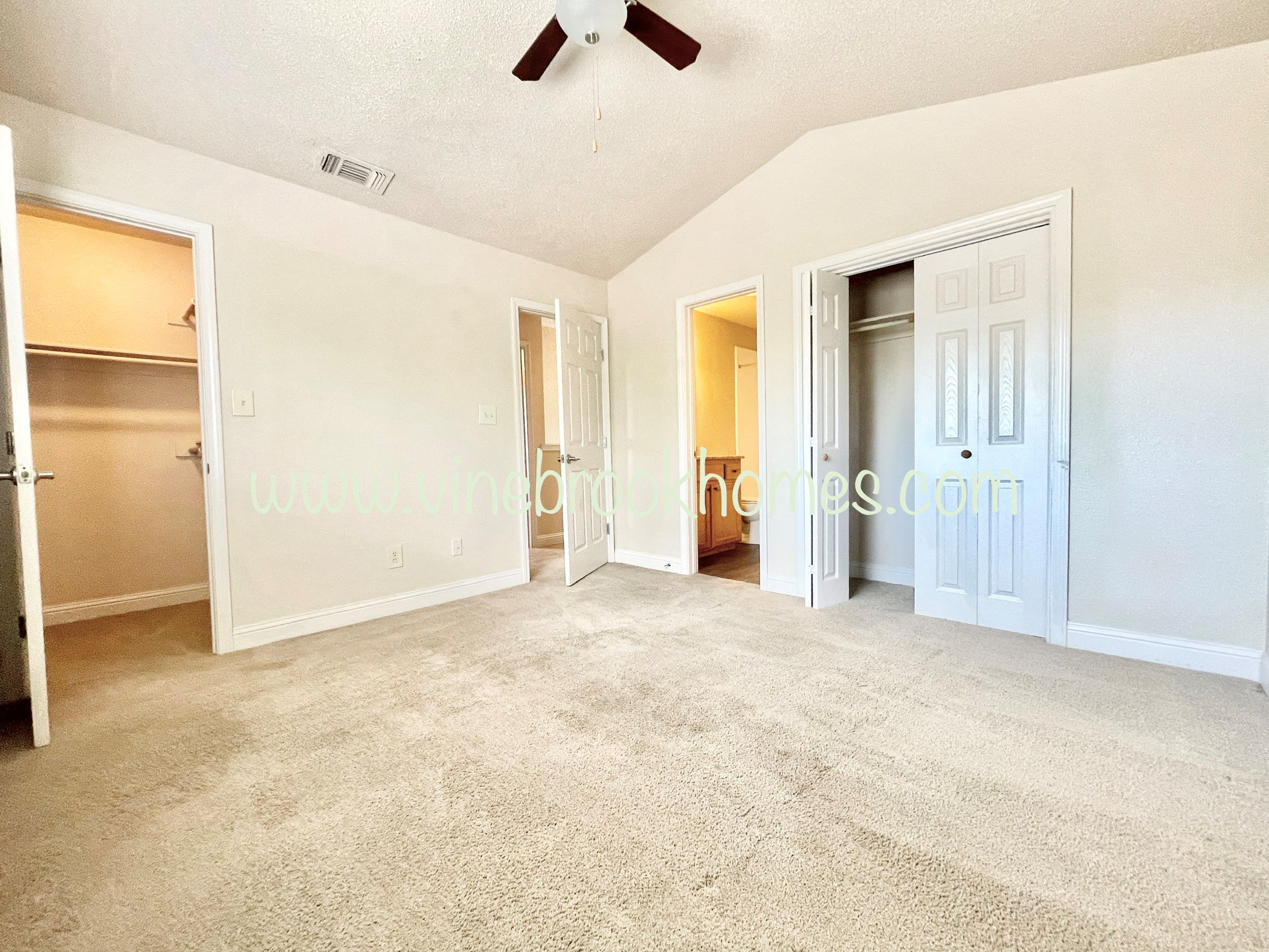 an empty living room with a closet and a door to a bedroom