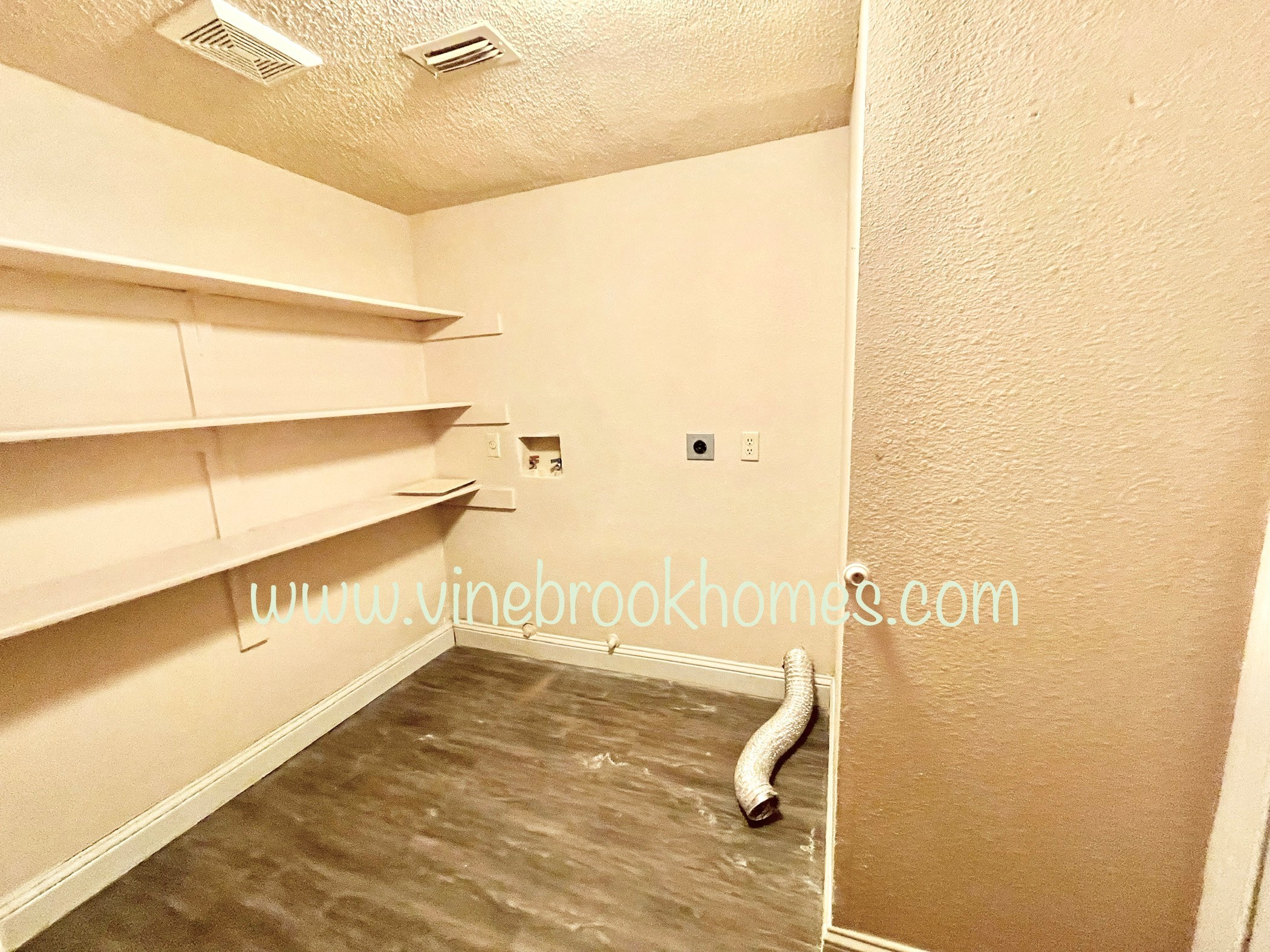 a small room with a closet and some shelves