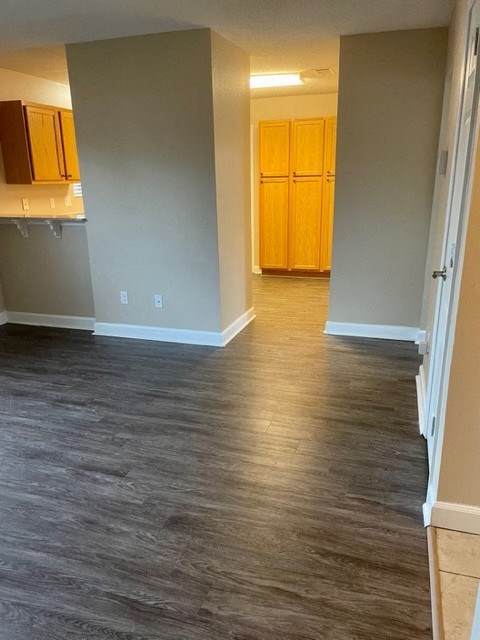 A room with wooden floors and a white door.