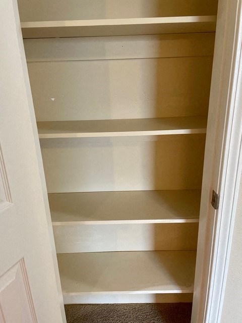 A white door with a shelf on it.