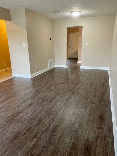 A room with a wooden floor and a door.