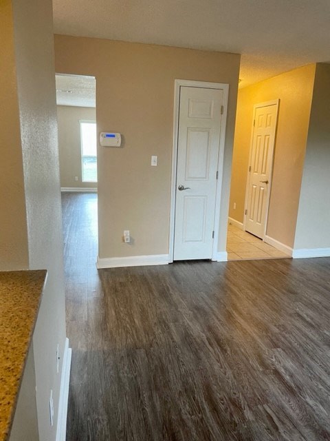 A room with a wooden floor and a white door.