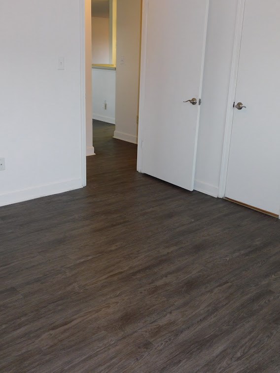 a living room with a hard wood floor and white doors