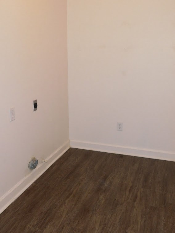 an empty room with white walls and a wooden floor