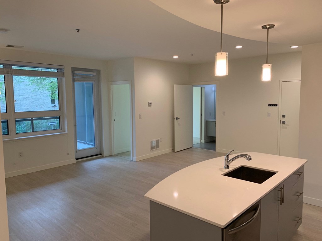 an empty kitchen and living room in a new home