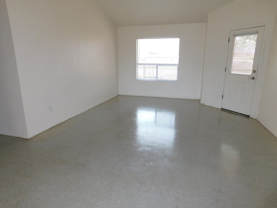 an empty room with a door and a window in it