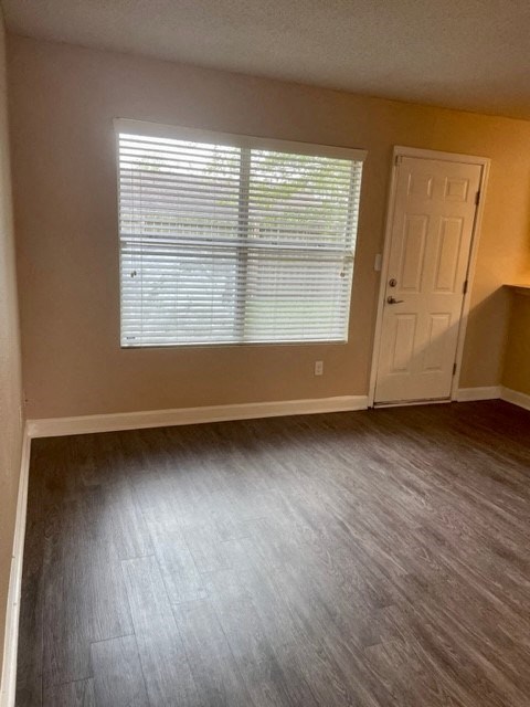 an empty room with a door and a window