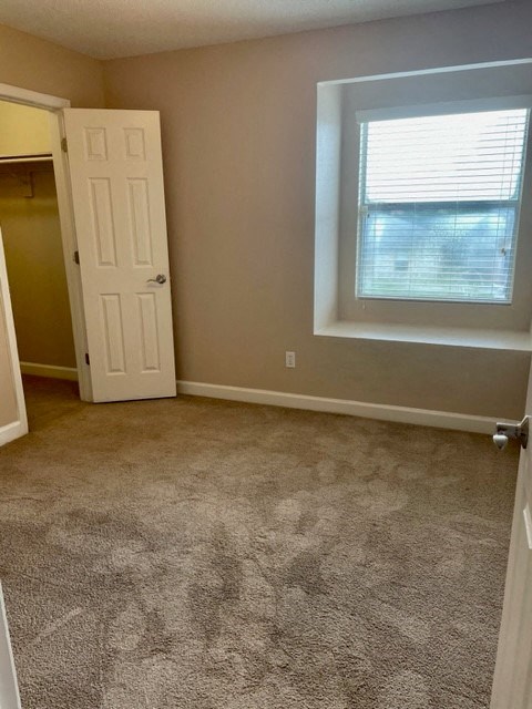 an empty room with a door and a window