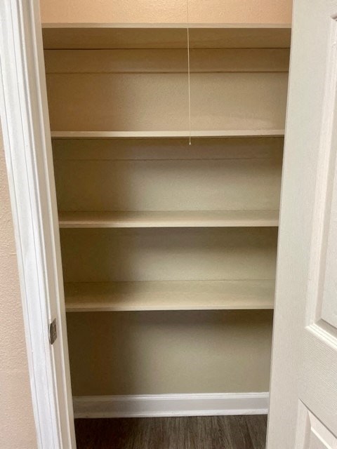 a closet with empty shelves and a door